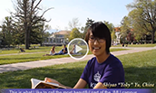 A JMU student reads a book on the Quad