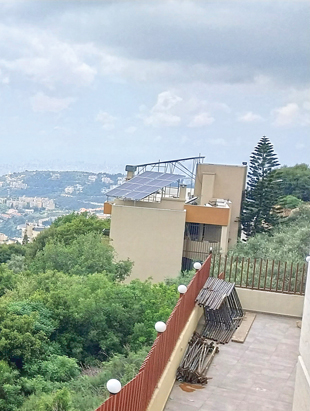 A solar installation on a tan apartment building in Lebanon.