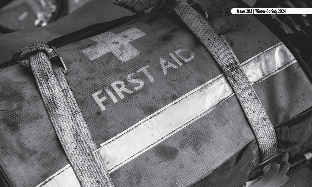 Black and white image of a worn first aid bag.