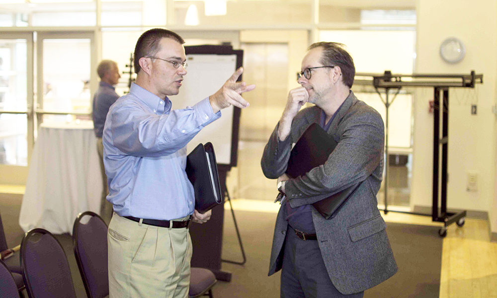 Tim Louwers talking with another professor at the 2017 Teaching Academy