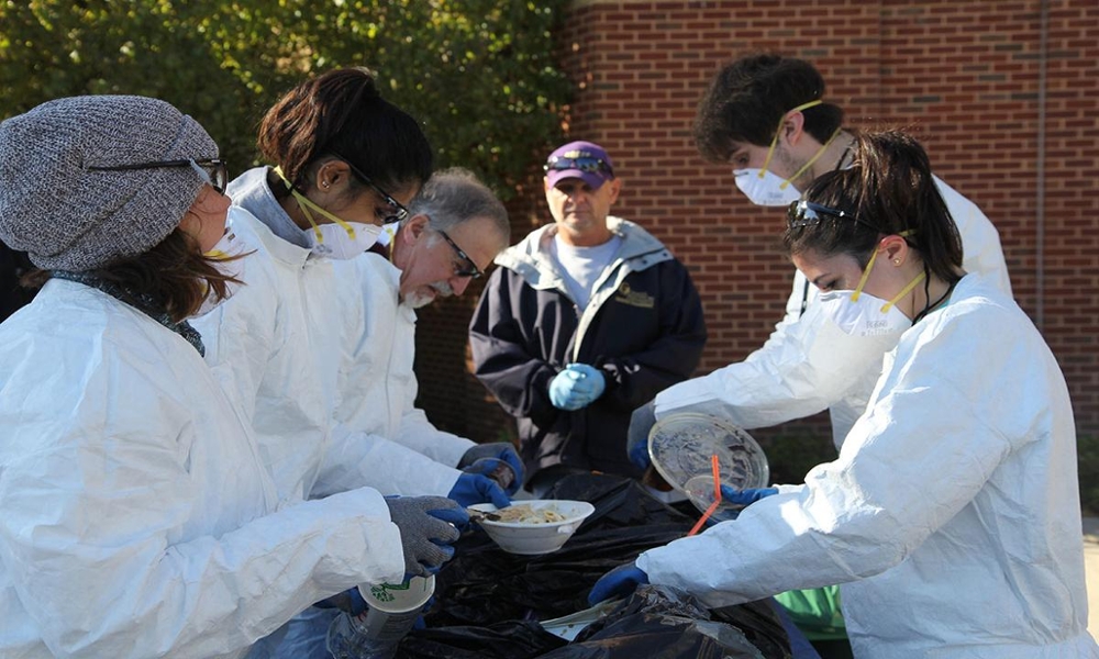 Group of College of Business Students and Faculty sorting trash 2015