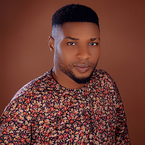 a portrait of Martins Deep, a Black man wearing a colorful patterned shirt.