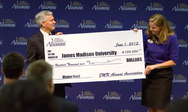 JMU alumni association president Jamie Jones Miller presents check to President Alger for Madison Forever Vision Fund