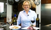Tassie Pippert in kitchen with wine and lamb chops - 2018