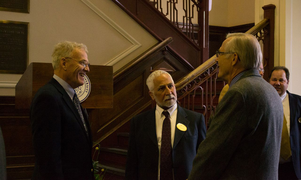 Professor Emeritus of Communication and JMU Faculty Emeriti Association President Rex Fuller and Dean of Libraries and Educational Technologies Ralph Alberico (center) talk with faculty emeriti members at the reception.