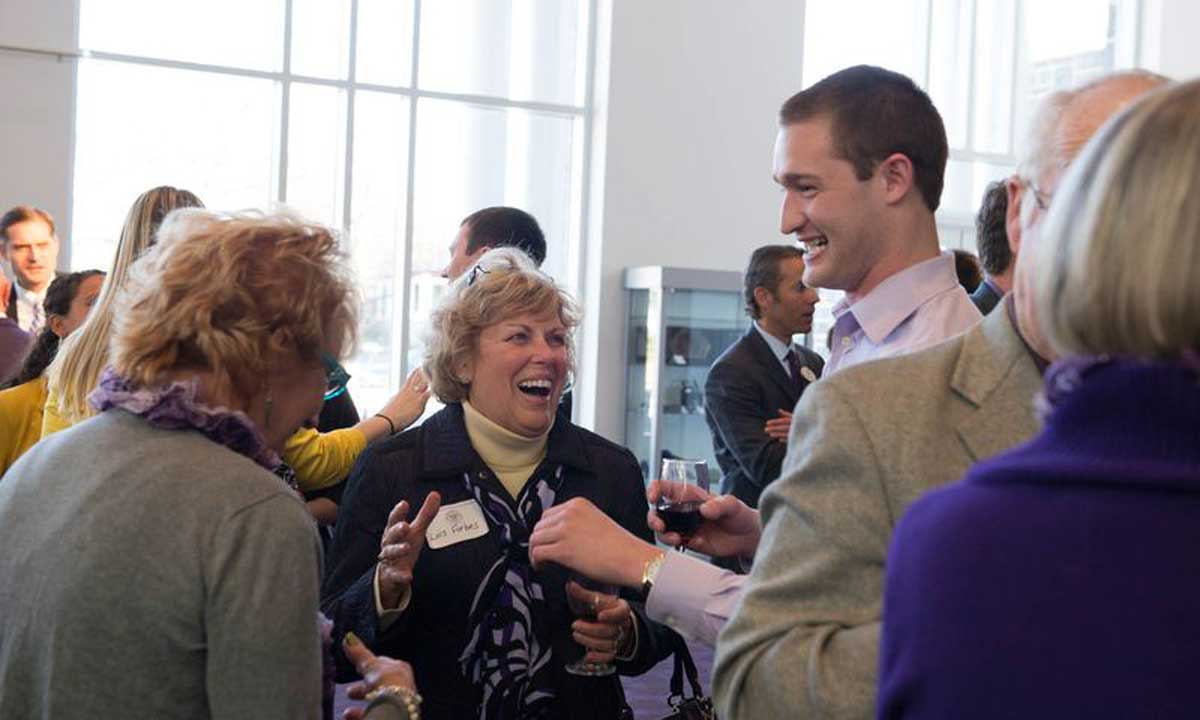 Lois Cardarella Forbes ('64) chats with alumni at reception. Longtime JMU supporters Forbes and her husband, Bruce, funded the Forbes Center, donated a James Madison statue and established a Forbes Family Scholarship.