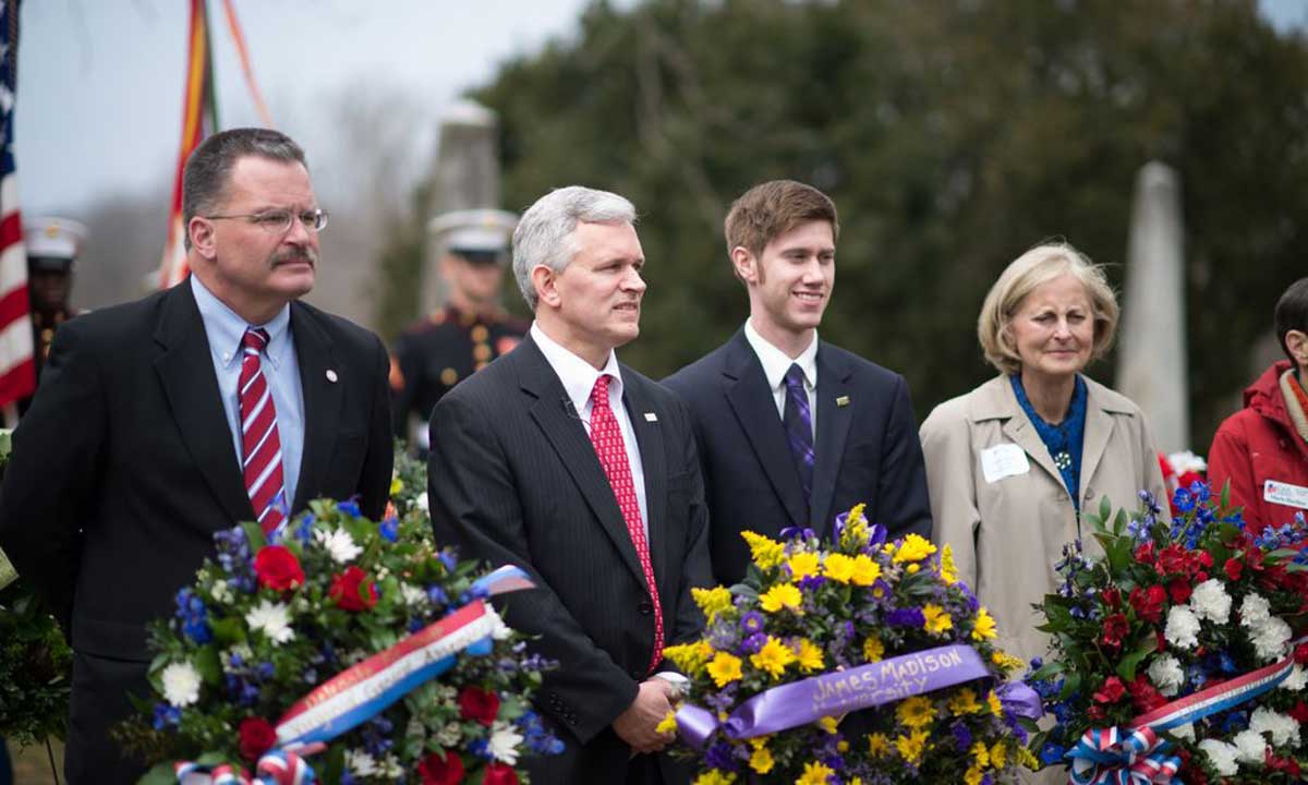 Jon Alger (second from left) and Matt Klein (center), president of the Student Government Association, presented a ceremonial wreath on behalf of JMU at the gravesite of James Madison at Montpelier on Saturday. 