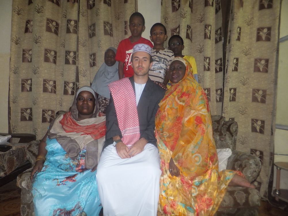 Andrew Reese in traditional African garb with African host family.