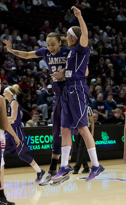 JMU women's basketball players Jazmin Gwathmey (left) and Kirby Burkholder (right) celebrate their victory over Gonzaga University in the 2014 NCAA Women's Basketball Tournament.