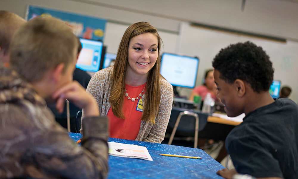 Allison Rhoten works with students in her class.