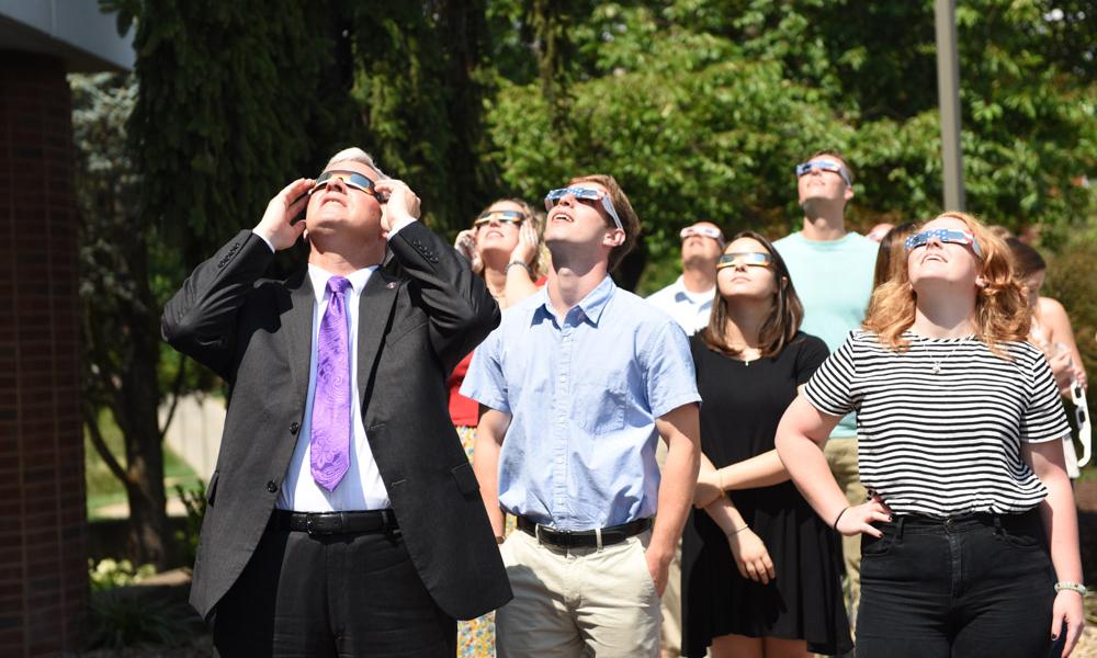 President Alger views solar eclipse with students