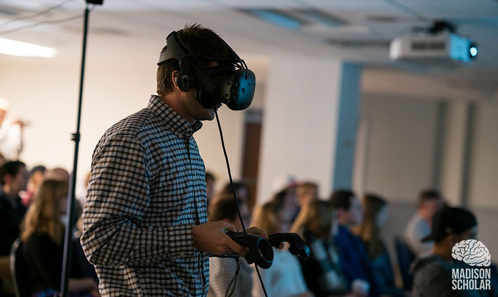 student presenting wearing virtual reality goggles