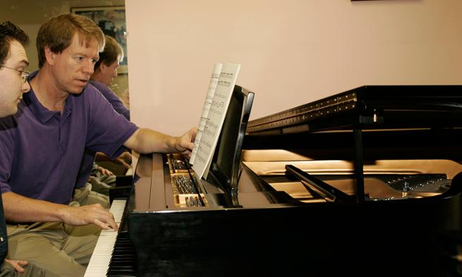 Professor Eric Ruple with student during piano lesson