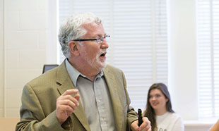 Photo of Bill Hawk teaching students about ethical reasoning