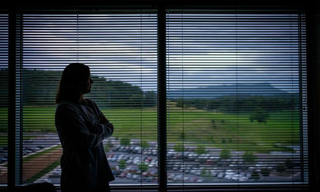 Photo of JMU nursing professor Erica Lewis gazing out hospital window
