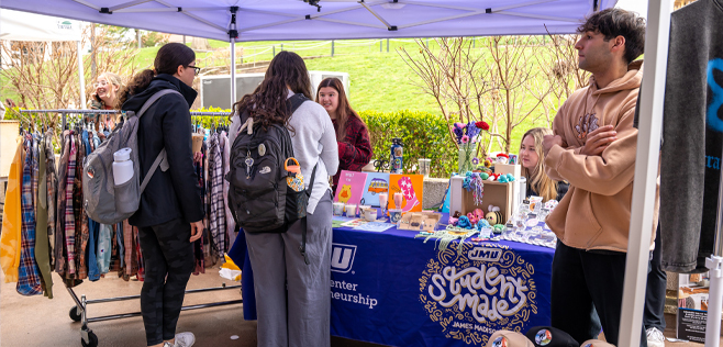 Student sell their handmade goods under a tent at JMU's farmers market
