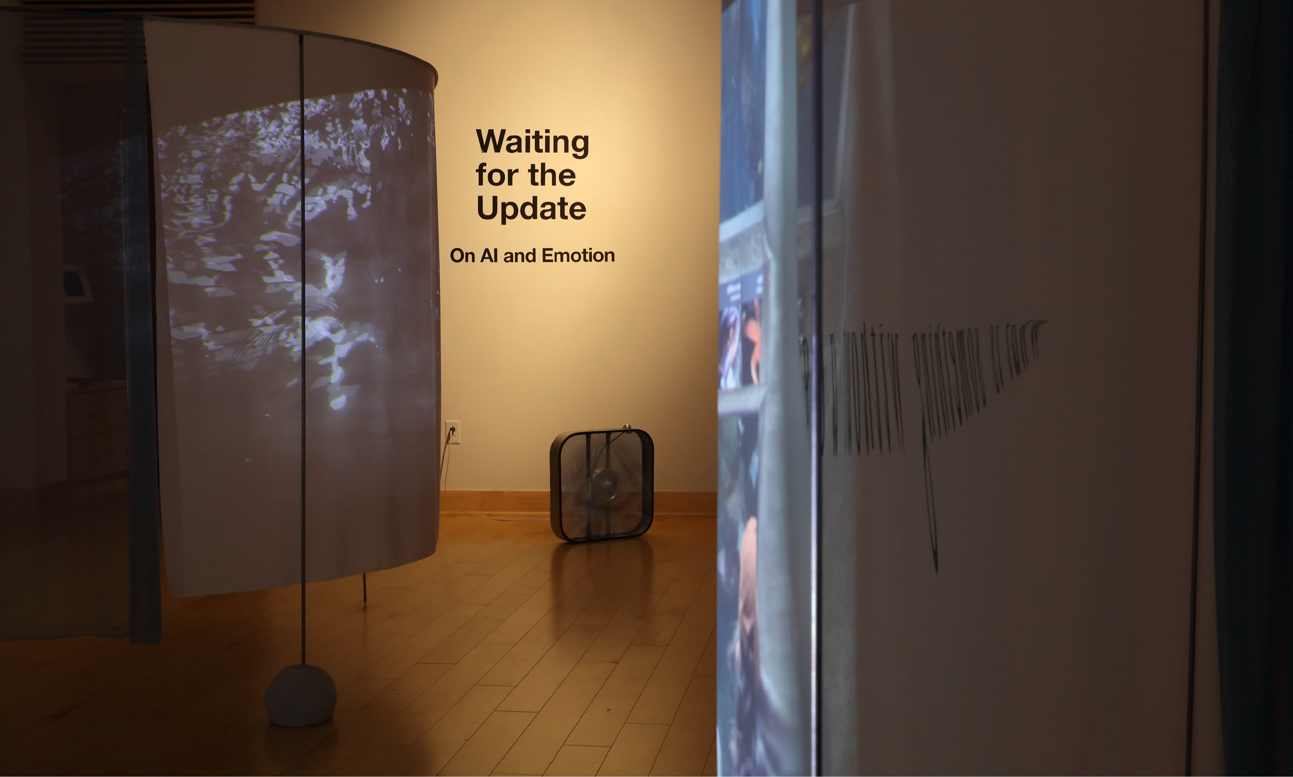 The exhibition's wall text reads: Waiting for the Update, On AI and Emotion