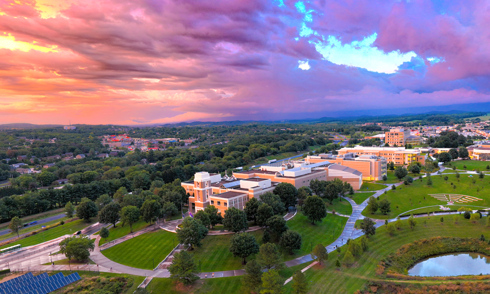 A drone’s eye view of the ISAT building with a sunset