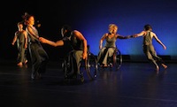 Photo of 2 dancers in wheelchairs with 3 other dancers