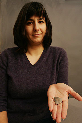 Julie Solometo holds out a sharp-edged fragment of a projectile in the palm of her hand.