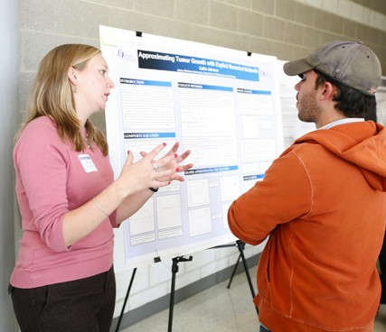 A student presents her poster.