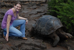 Julia Stutzman poses as a tortois walk past.
