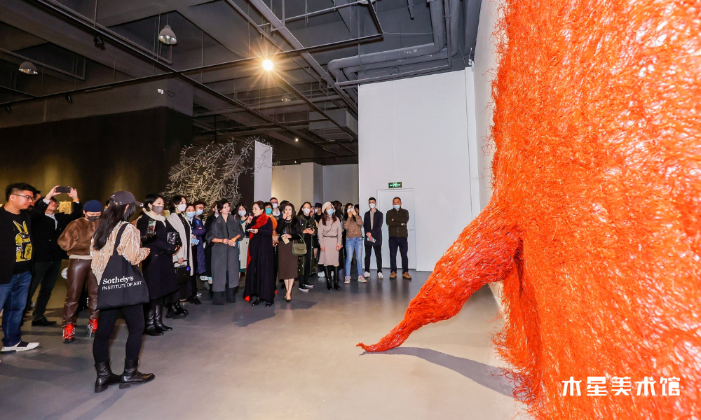 MiKyoung's piece "Symbiosis" at the exhibition's opening. Red constructed textile piece