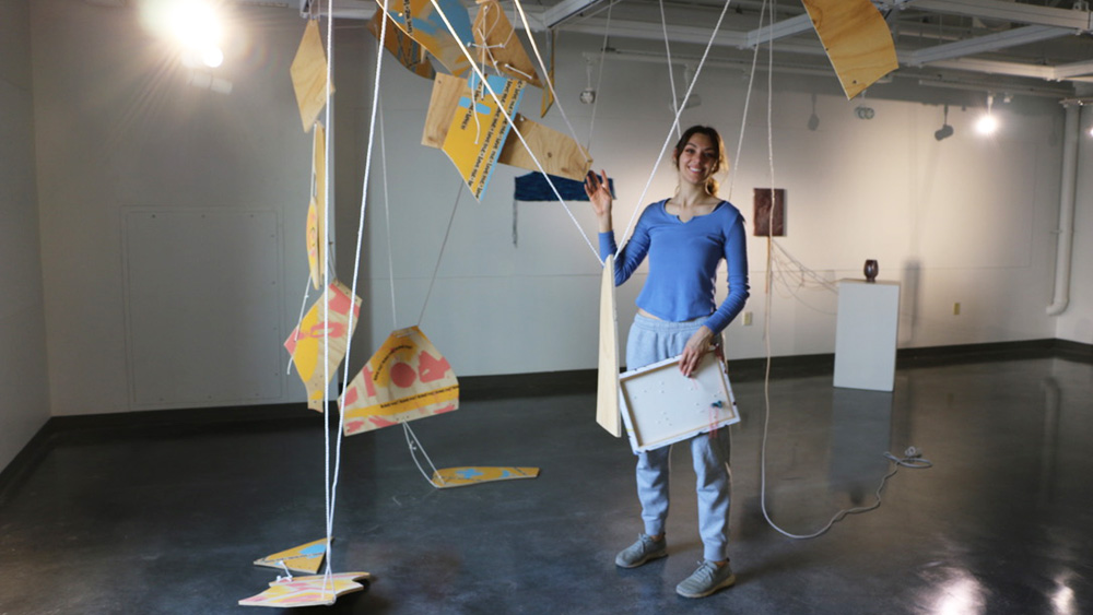 Student setting up exhibition