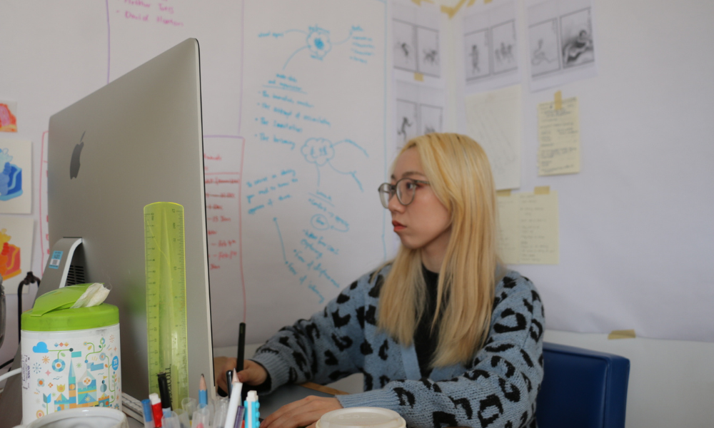 Yulin Yuan works on the computer in her studio