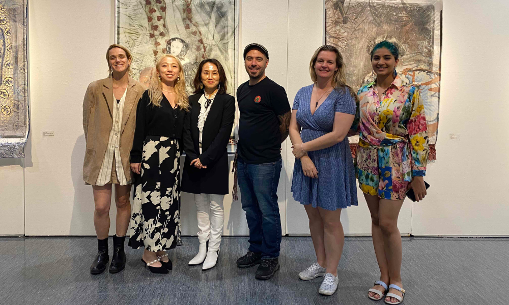 IFAF team poses in front of Corinne Diop's work.