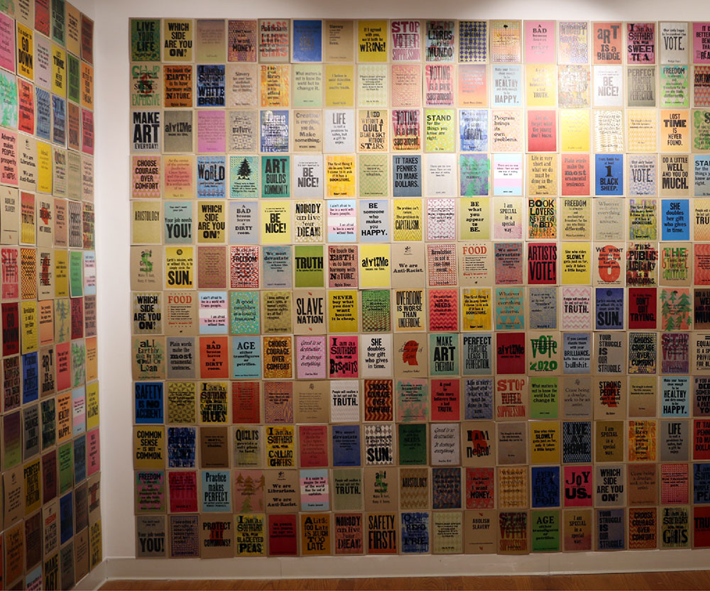 Hundreds of prints covering the walls of a small gallery