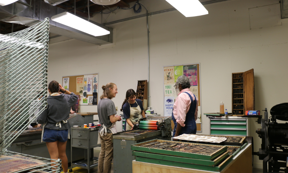 Amos Paul Kennedy, Jr. works with students in the studio.