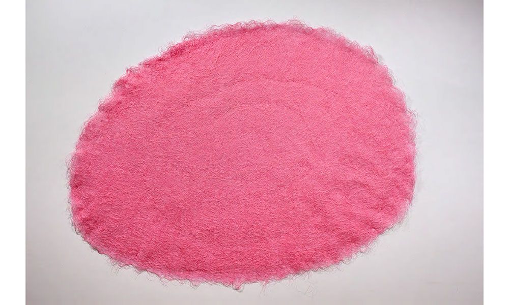 A large flat circle composed of pink sewing thread.