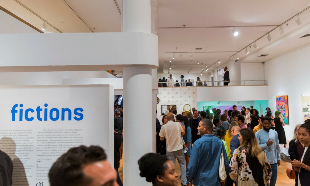 Fictions exhibit sign with attendees