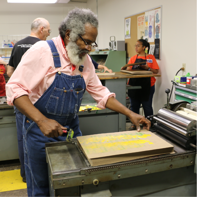 Amos Paul Kennedy, Jr. works in the studio with students