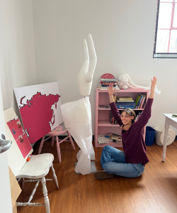 student inspecting trousers for art exhibition