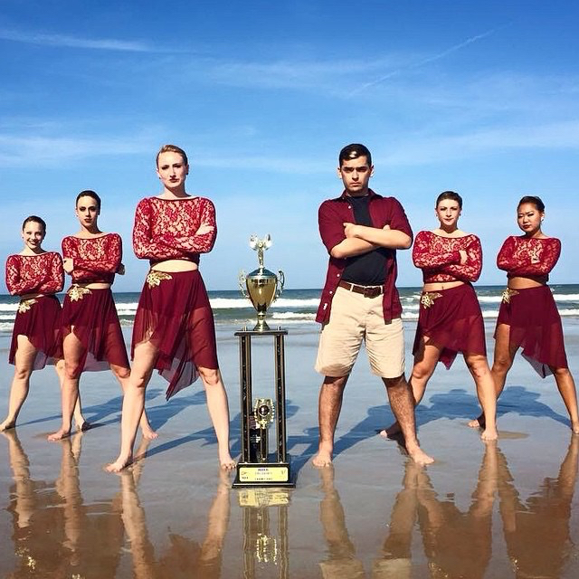 The Dukettes take a photo next to their trophy