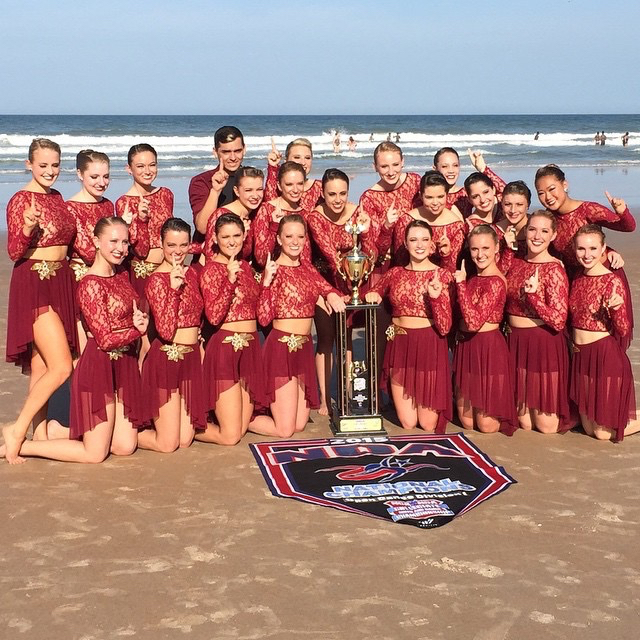 The JMU Dukettes pose on the beach after their win