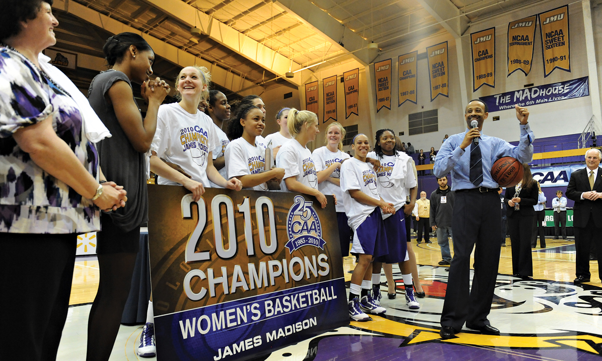 The JMU Women's Basketball team celebrates a CAA Championship.