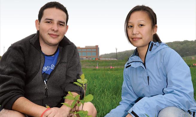 ISAT majors Nicolas Jaramillo ('09) and Bonnie Tang ('09) check a tree sapling.