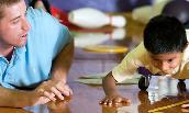 A JMU student works with child as part of the Overcoming Barriers program 