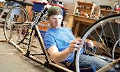 J.T. Danko ('10) checks the wheel on the supermileage vehicle he helped build in the JMU Alternative Fuels Lab.