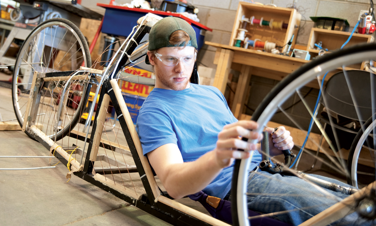 J.T. Danko ('10) checks the wheel on the supermileage vehicle he helped build in the JMU Alternative Fuels Lab.