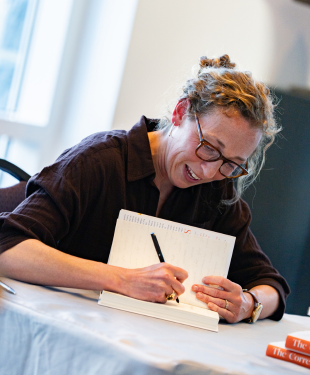 Virginia Evans signing a copy of her book for a Q&A attendee.