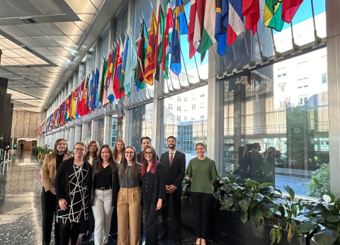 A group photo of Christie Kilby and her students in the lobby of the Harry S. Truman Building in Washington, D.C.