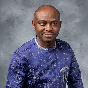 Ebeneezer Aidoo, wearing a deep blue patterned tunic.