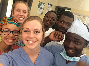 Six people bunched close together for a selfie.