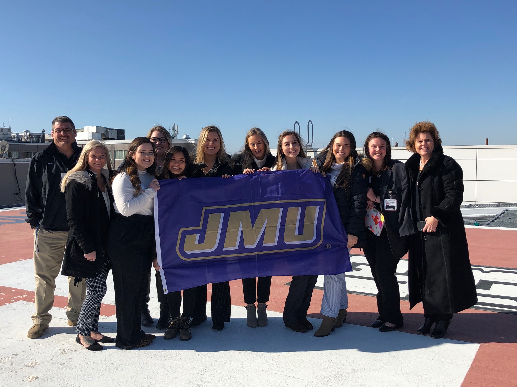 jmu-students-hold-flag-on-helicoptor-landing.jpg