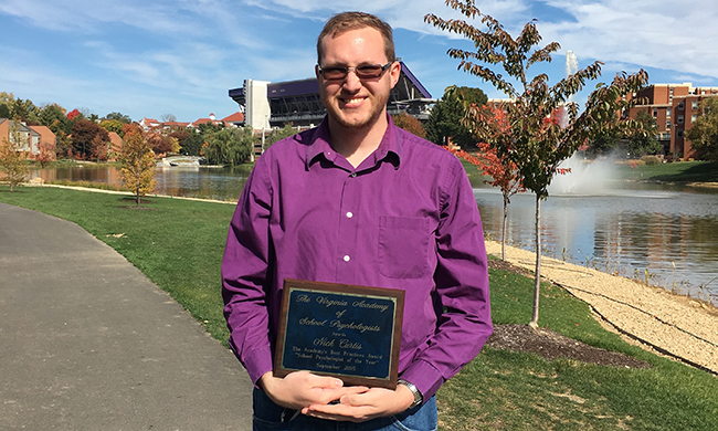 Nick Curtis holding award