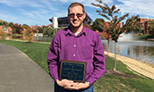 thumbnail of Nick Curtis holding award